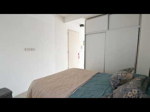 A studio apartment that can be divided into two rooms, with a bright front-facing balcony