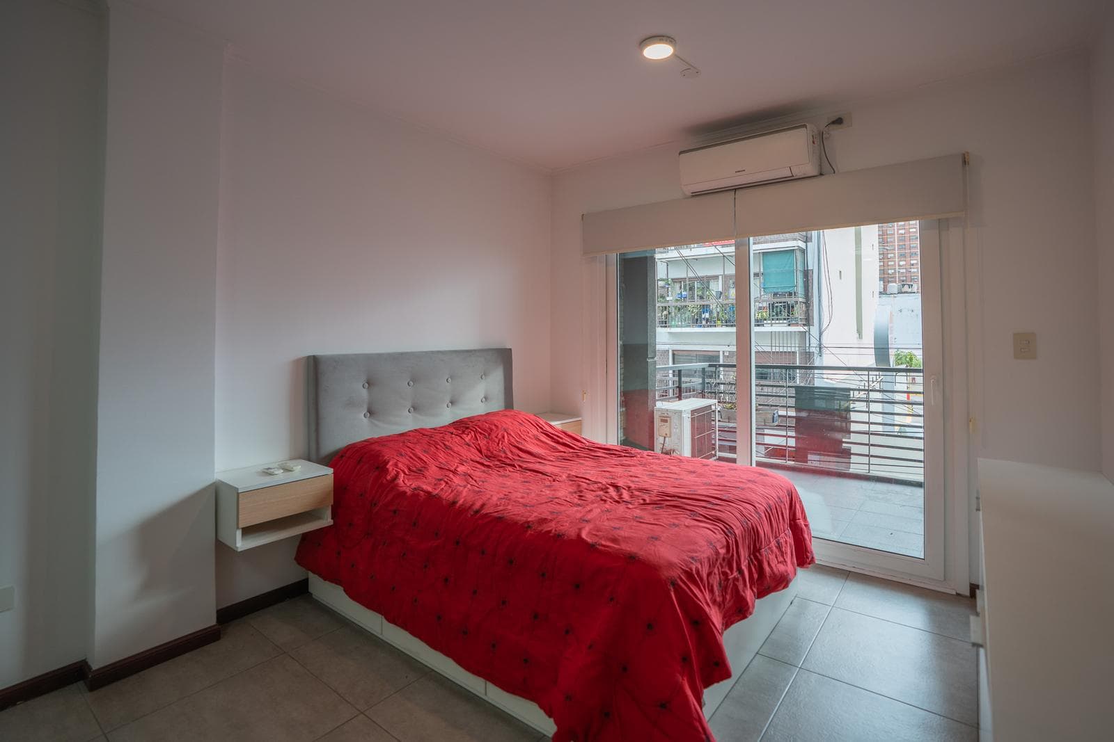 Modern studio apartment with a balcony facing the street