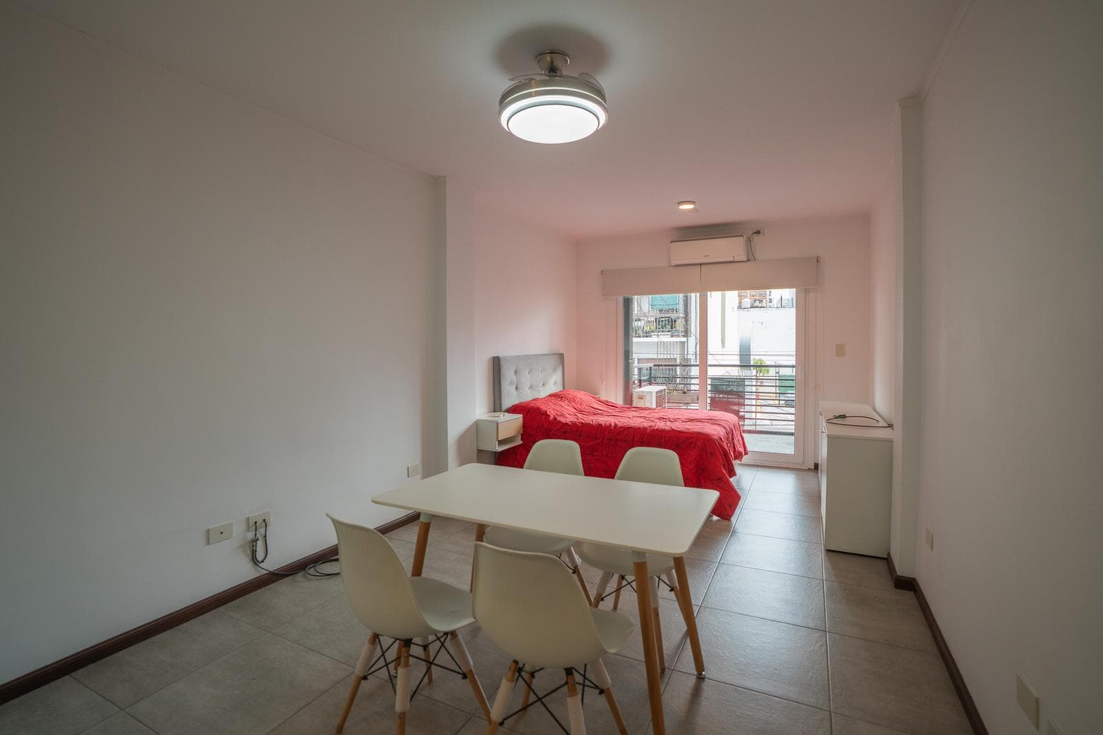 Modern studio apartment with a balcony facing the street