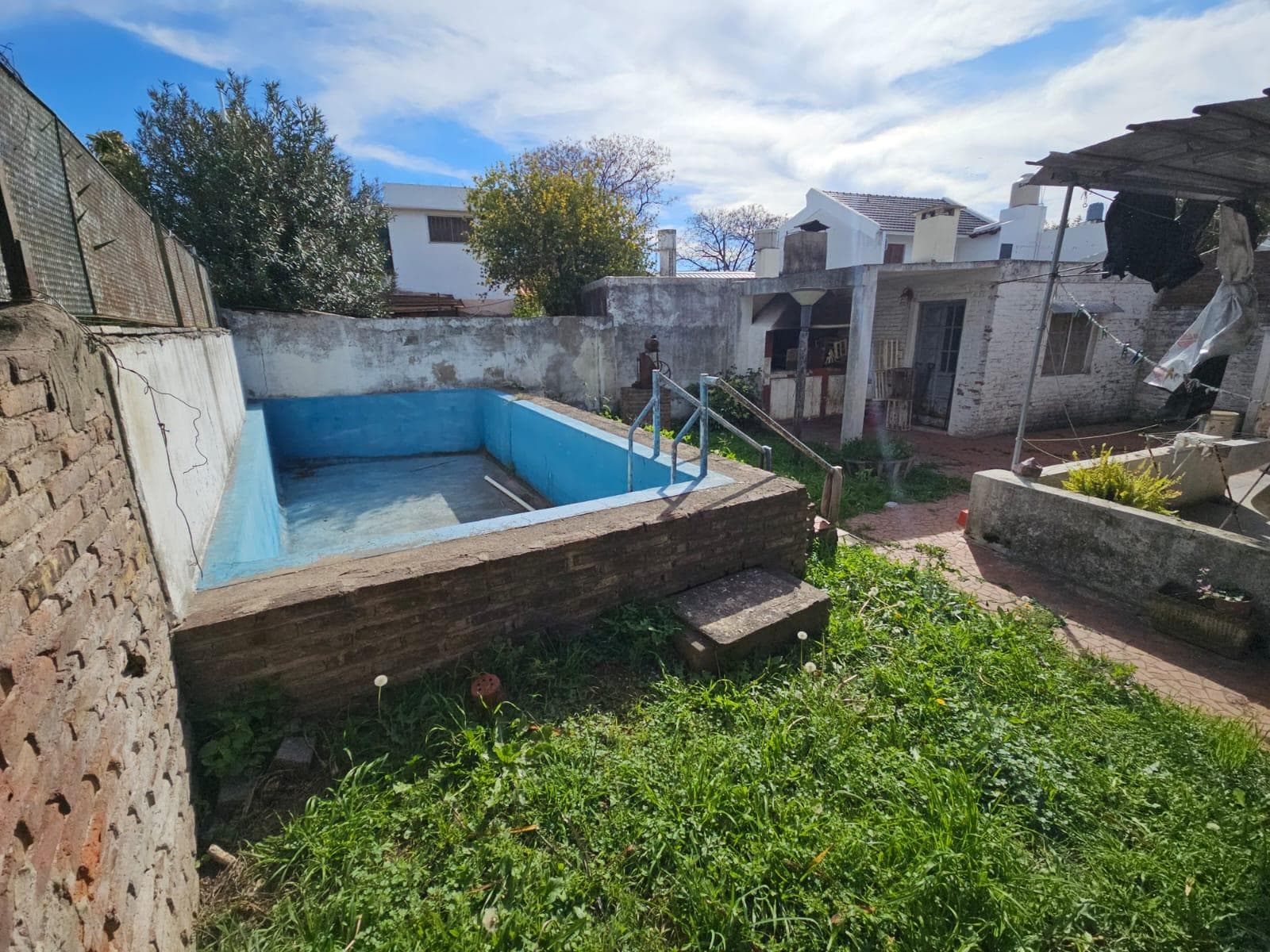 FOR SALE: TWO-BEDROOM HOUSE WITH GARAGE AND GREEN YARD WITH A POOL