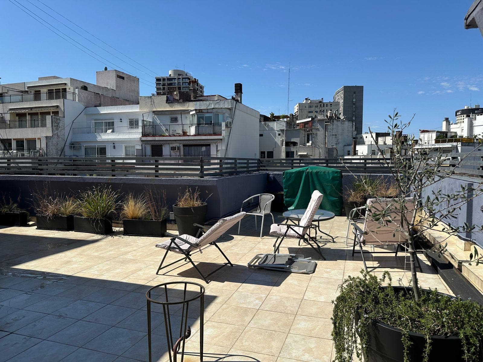 Luxury 5-room apartment for sale, with a terrace and a sun-filled multipurpose room, plants, and a grill on Quintana Avenue