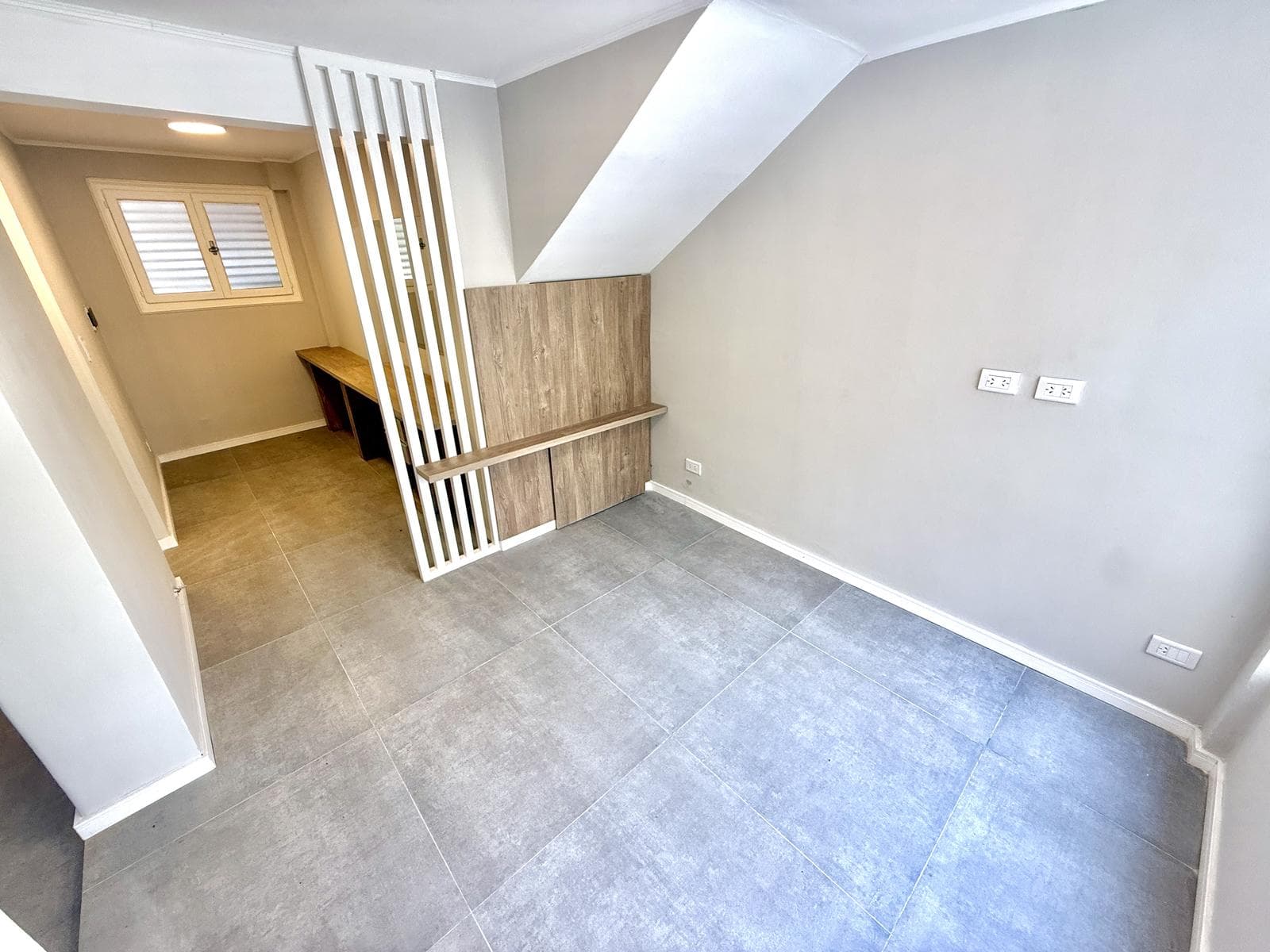 2-bedroom house on the street with a garage