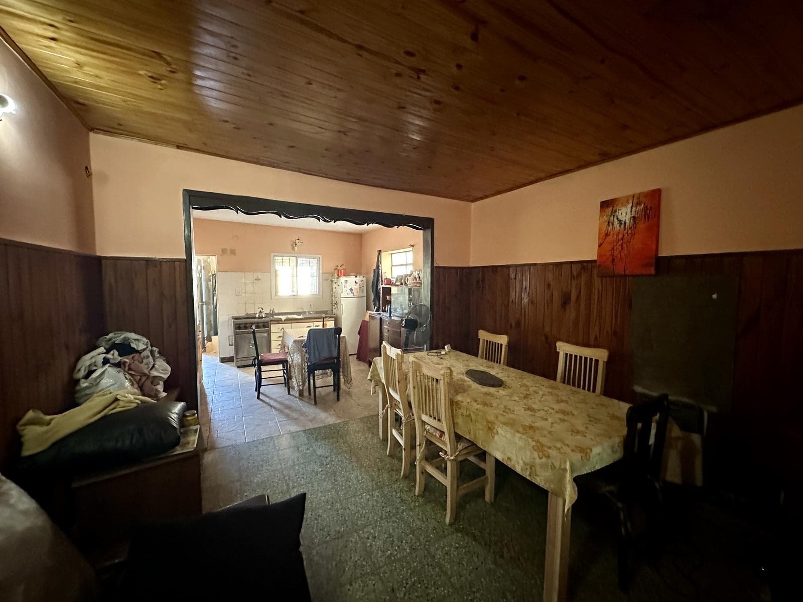 2-bedroom house for sale. Porch with laundry area. Backyard with grill. Range hood