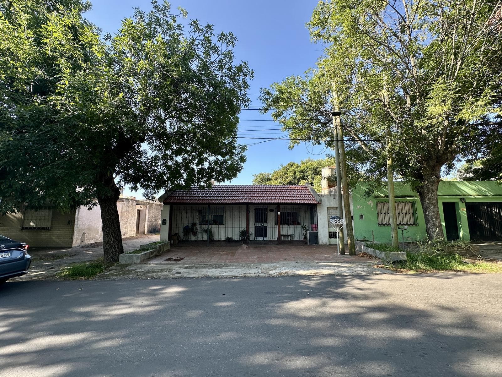 2-bedroom house for sale. Porch with laundry area. Backyard with grill. Range hood
