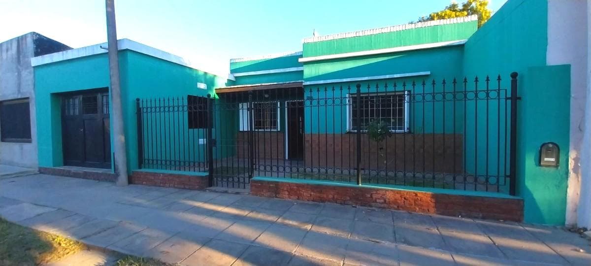 Two-bedroom house with a garage and a backyard with a grill
