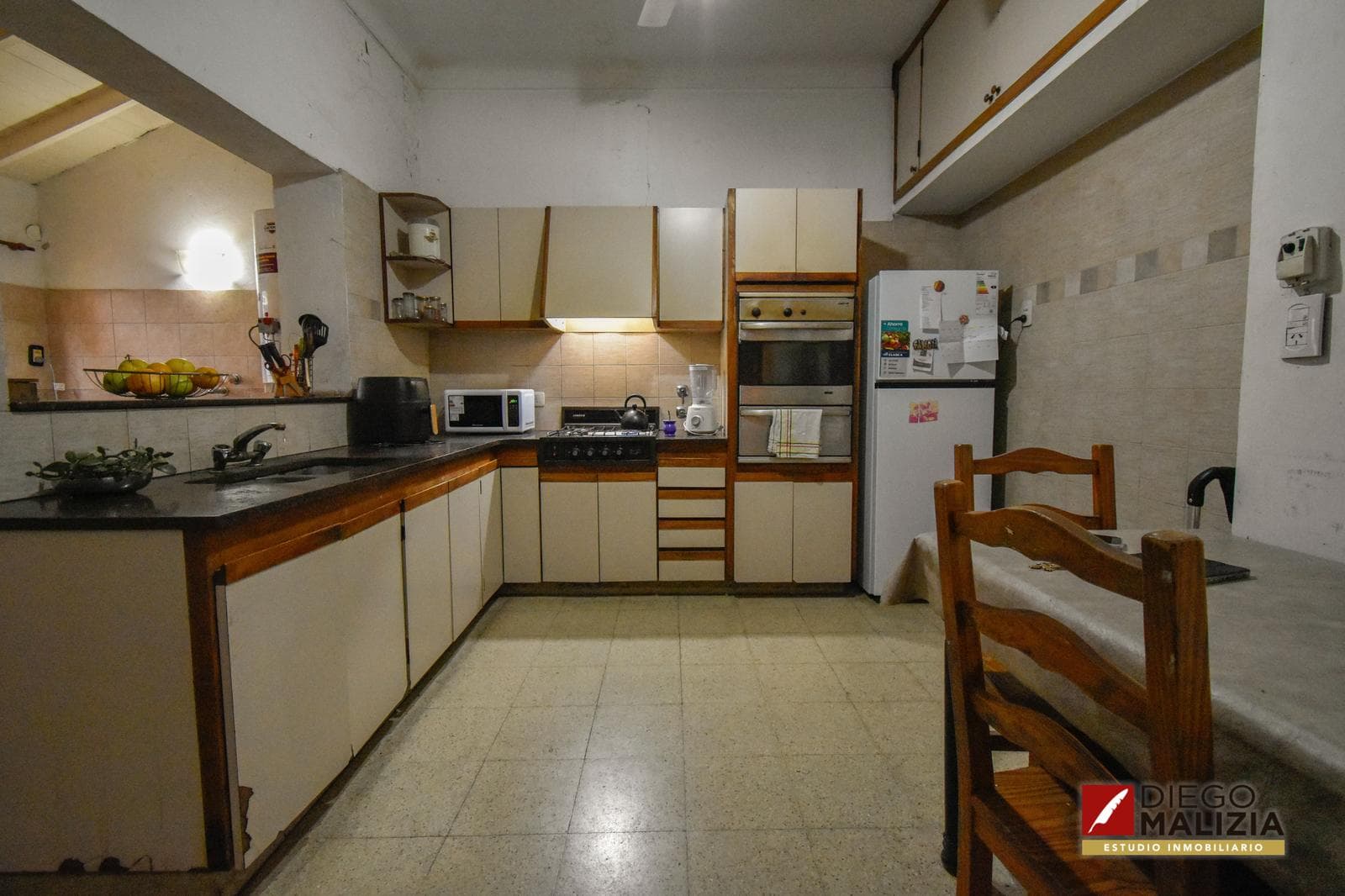 5-room house with a patio, grill, outdoor dining area, and garage for sale in Banfield