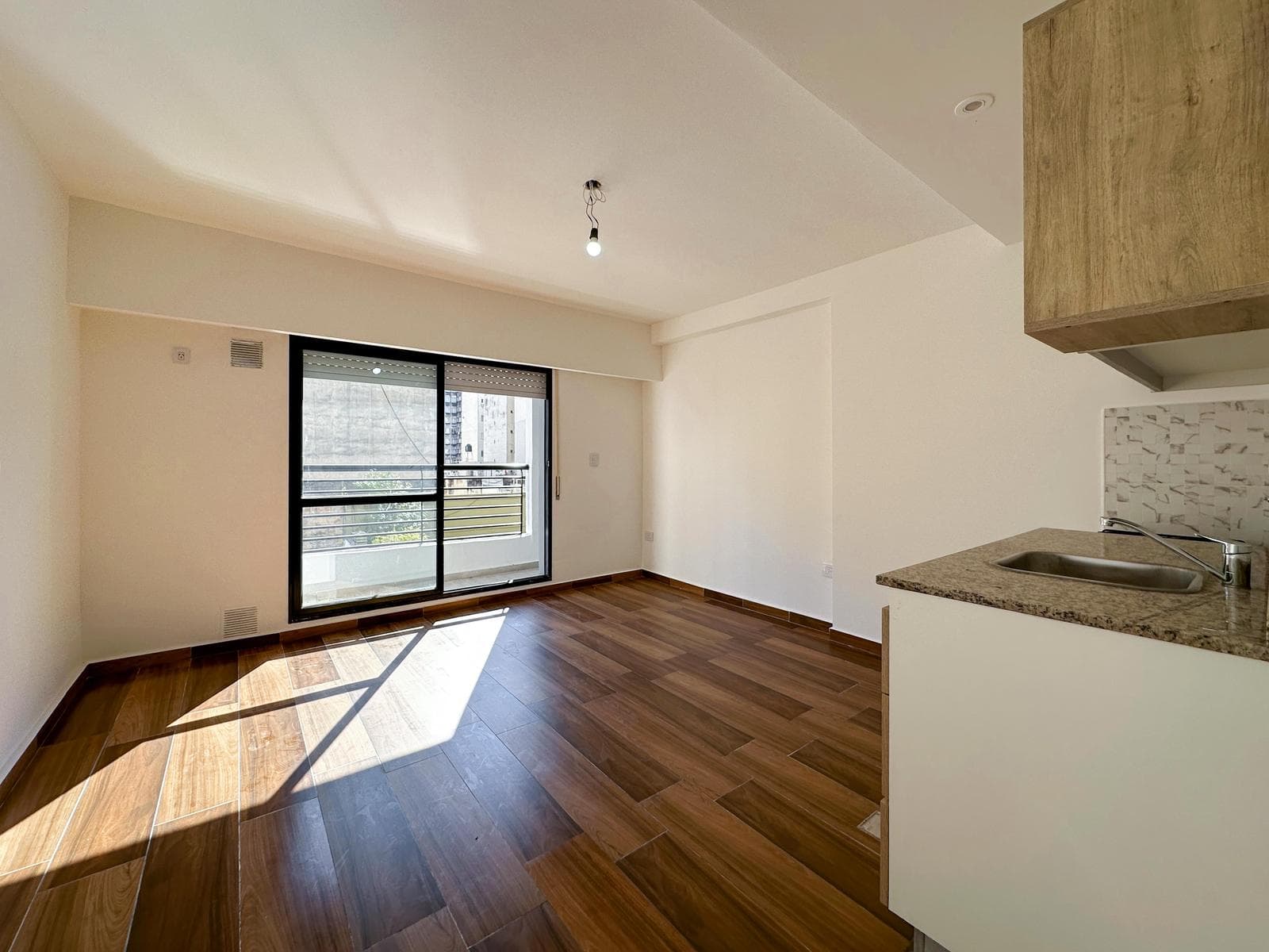 Brand-new studio apartment with a balcony facing the rear of the building