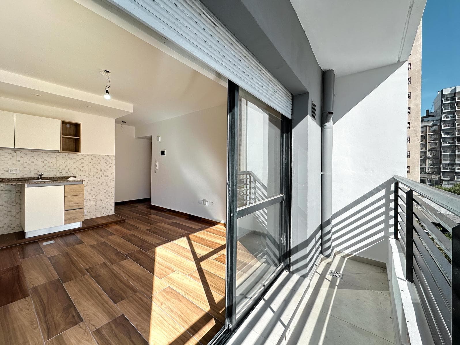 Brand-new studio apartment with a balcony facing the rear of the building