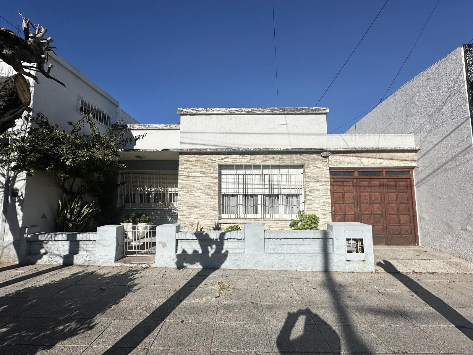2-bedroom house for sale. Backyard with a grill and a patio. Garage. Downtown Campana