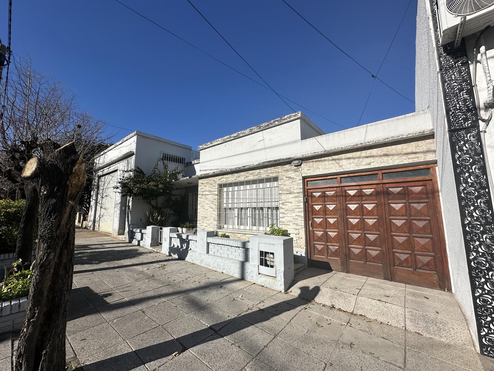 2-bedroom house for sale. Backyard with a grill and a patio. Garage. Downtown Campana