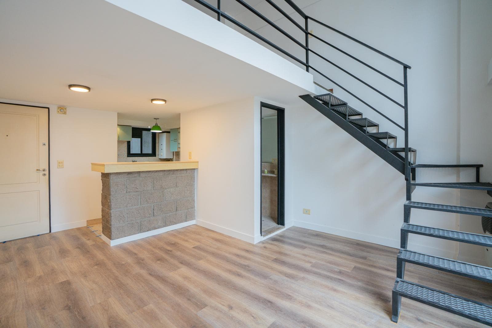 A very bright loft-style apartment with a balcony facing the street