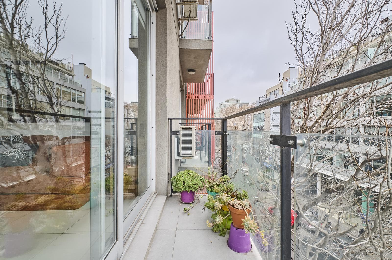 A studio apartment that can be divided into two rooms, with a bright front-facing balcony