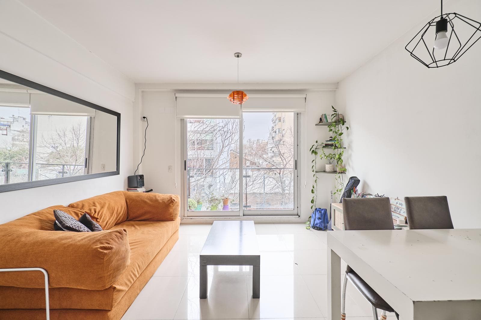 A studio apartment that can be divided into two rooms, with a bright front-facing balcony