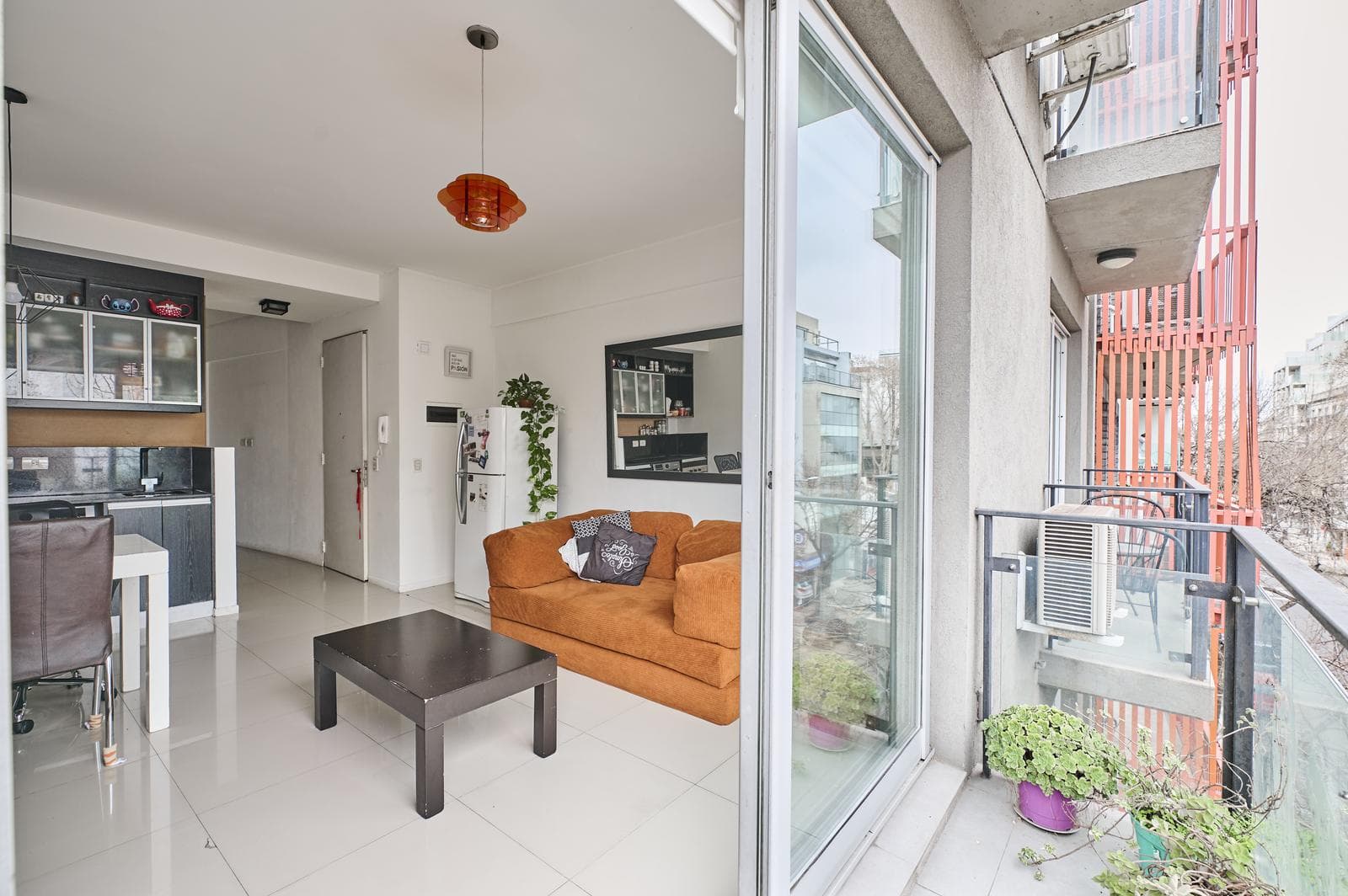 A studio apartment that can be divided into two rooms, with a bright front-facing balcony