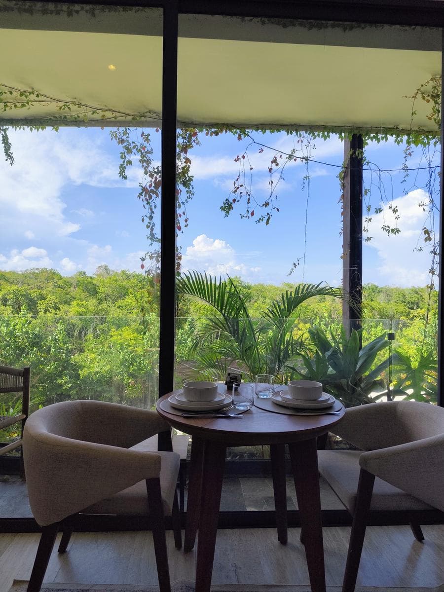 A studio apartment with an open, loft-style layout surrounded by nature in one of Tulum's best condominiums