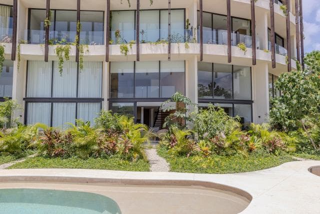 A studio apartment with an open, loft-style layout surrounded by nature in one of Tulum's best condominiums