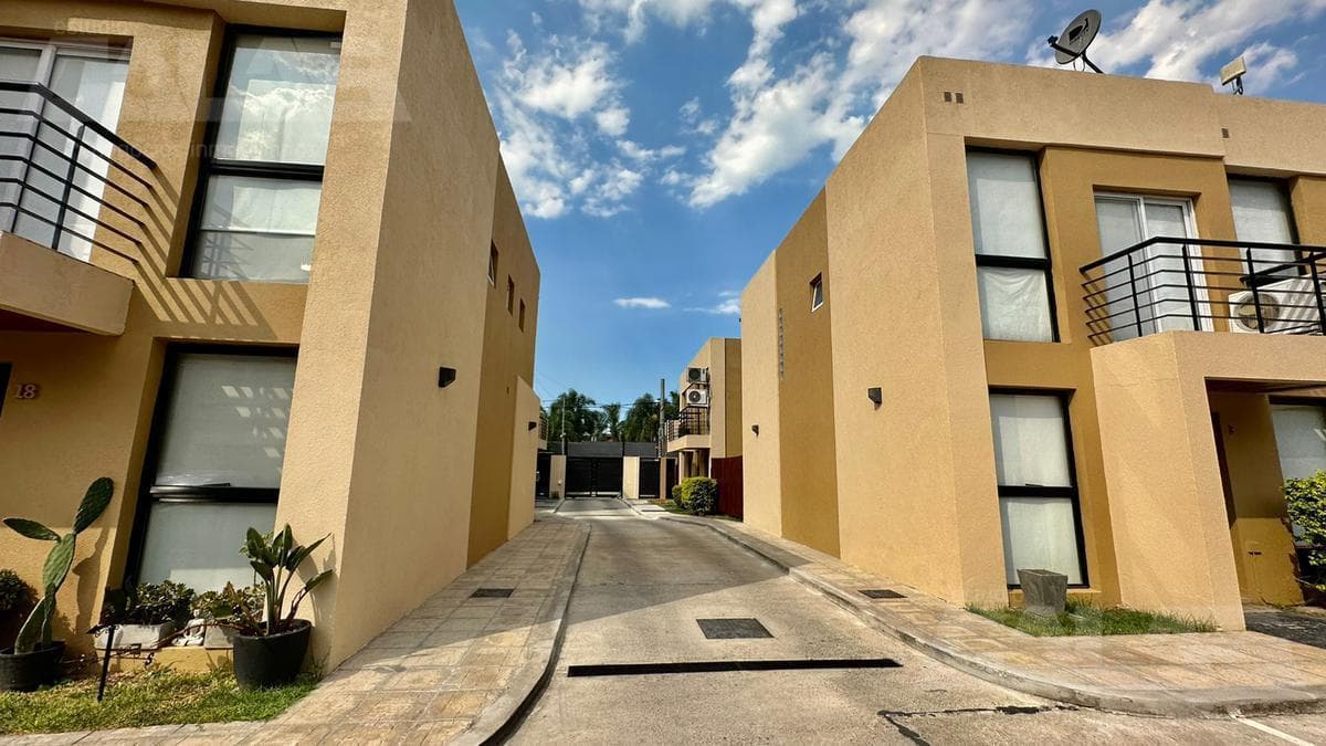 3-bedroom duplex in a gated community, with a garage, open lot, and security, plus low maintenance fees