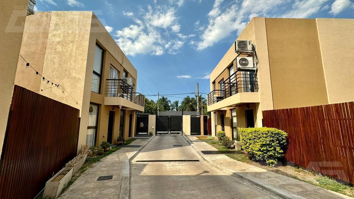 3-bedroom duplex in a gated community, with a garage, open lot, and security, plus low maintenance fees